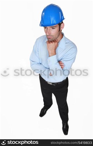 contemplative foreman with face resting on fist