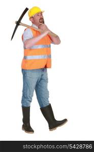 Contemplative labourer holding a pickaxe