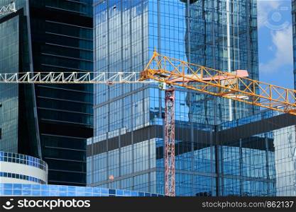 Contemporary architecture and construction site with cranes.