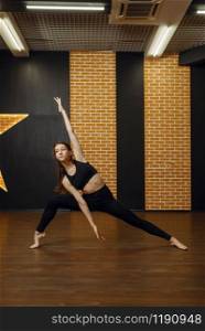 Contemporary dance performer, woman in studio, body flexibility. Dancer on workout in class, modern ballet, elegance dancing, stretching exercise