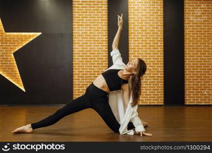 Contemporary dance performer, woman in studio, body flexibility. Dancer on workout in class, modern ballet dance. Contemporary dance performer, woman in studio