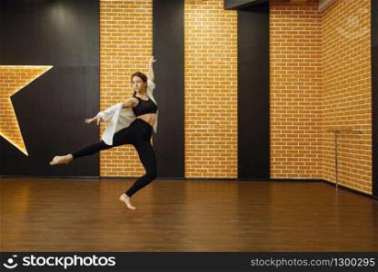 Contemporary dance performer, woman in studio, body flexibility. Dancer on workout in class, modern ballet dance. Contemporary dance performer, woman in studio
