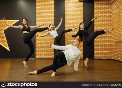 Contemporary dance performers posing in studio. Female and male dancers training in class, modern grace dancing, stretching exercise, acrobats. Contemporary dance performers posing in studio