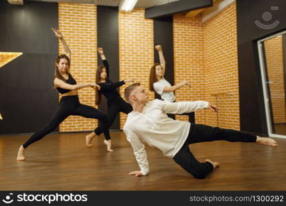 Contemporary dance performers posing in studio. Female and male dancers training in class, modern grace dancing, stretching exercise, acrobats