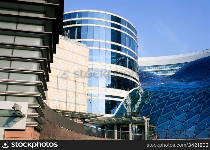Contemporary futuristic exterior architecture of a shopping mall and office buildings in the Warsaw downtown, Poland