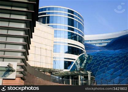 Contemporary futuristic exterior architecture of a shopping mall and office buildings in the Warsaw downtown, Poland
