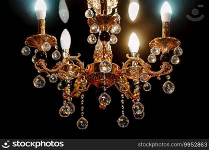 Contemporary glass chandelier isolated over black background. Chandelier for interior of the living room. Gold decoration.. Contemporary glass chandelier isolated over black background. Chandelier for interior of the living room. Gold decoration