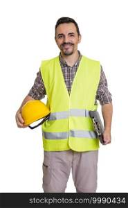 Content male constructor with yellow hardhat and clipboard standing on white background and looking at camera. Smiling builder in uniform on white background