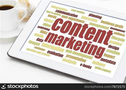 content marketing word cloud on a digital tablet with a cup of coffee