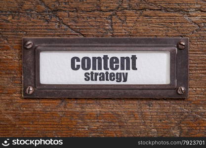 content strategy - file cabinet label, bronze holder against grunge and scratched wood