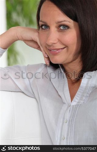 Content woman sitting on her sofa