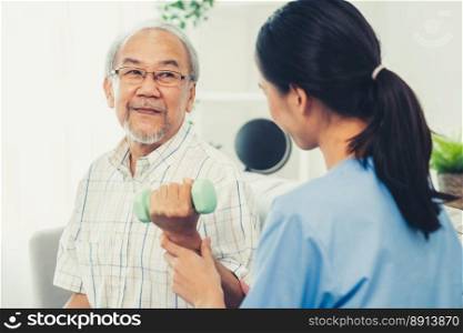 Contented senior patient doing physical therapy with the help of his caregiver. Senior physical therapy, physiotherapy treatment, nursing home for the elderly. Contented senior patient doing physical therapy with the help of his caregiver.