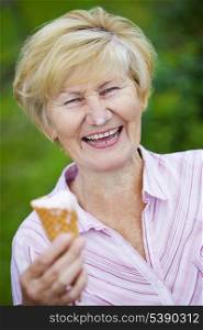 Contentment. Jubilant Ecstatic Old Woman Holding Ice-Cream and Laughing