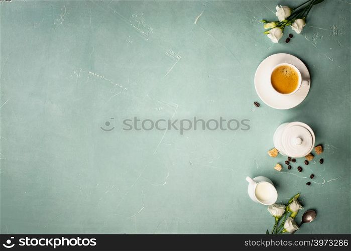 Continental breakfast captured from above top view, flat lay . Coffee, orange juice, croissants, jam, berry, milk and flowers. Blue concrete worktop as background. Layout with free text copy space.. Continental breakfast captured from above - space for text