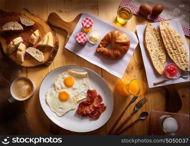 Continental breakfast croissant eggs bacon bread slices orange jiuce