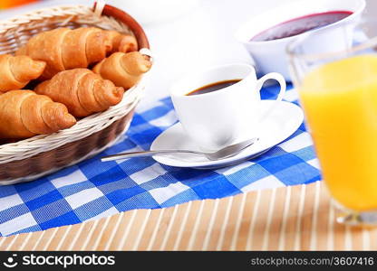 Continental breakfast with croisant and black coffee