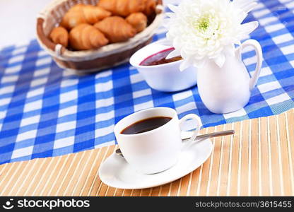 Continental breakfast with croisant and black coffee