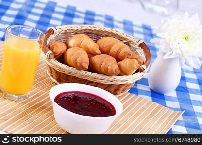 Continental breakfast with croissant and black coffee