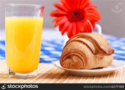 Continental breakfast with croissant and orange juice
