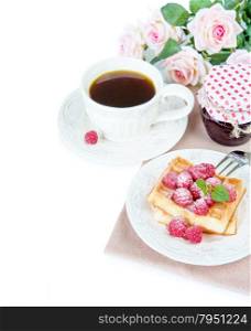 Continental breakfast with sweet waffles, raspberries and a cup of coffee