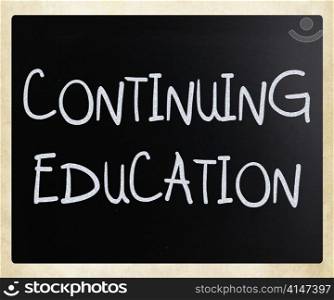""Continuing Education" handwritten with white chalk on a blackboard"