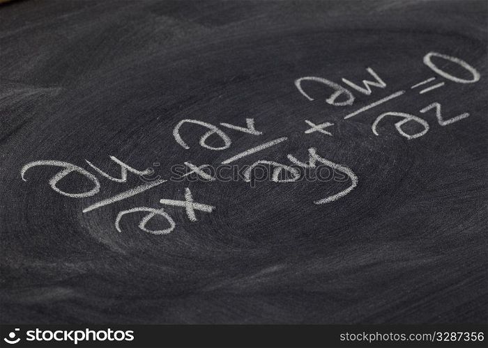continuity equation (mathematical physics) - white chalk handwriting on blackboard