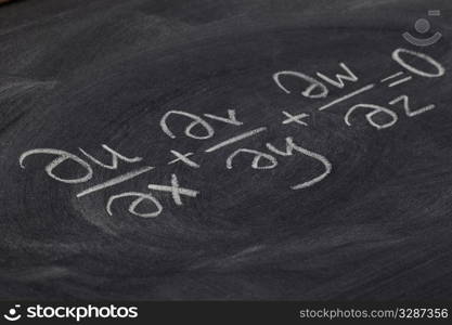 continuity equation (mathematical physics) - white chalk handwriting on blackboard