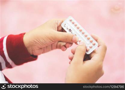 Contraception pills in hand woman holding / Birth control contraceptive means prevent pregnancy