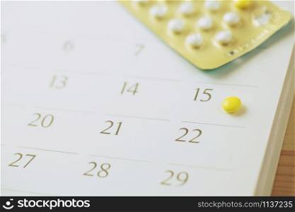 contraceptive control pills on date of calendar background. health care and medicine Birth control concept.