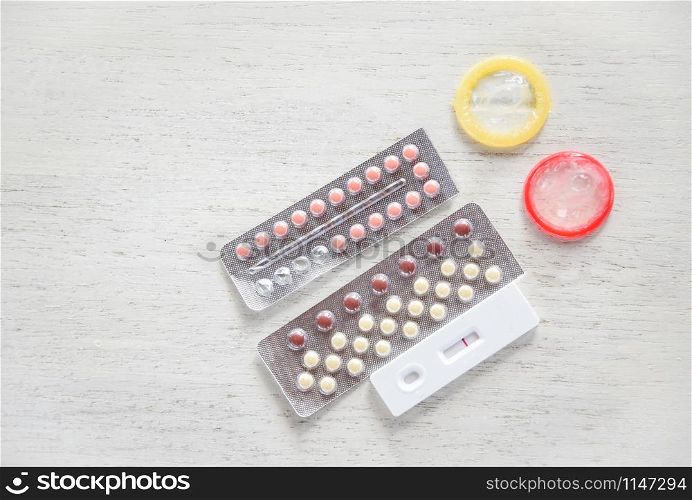 Contraceptive pill and Condom Prevent Pregnancy Contraception safe sex concept / Birth Control with Condom and Pregnancy Tests - sexually transmitted disease