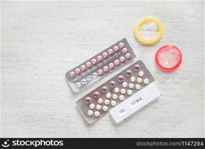 Contraceptive pill and Condom Prevent Pregnancy Contraception safe sex concept / Birth Control with Condom and Pregnancy Tests - sexually transmitted disease