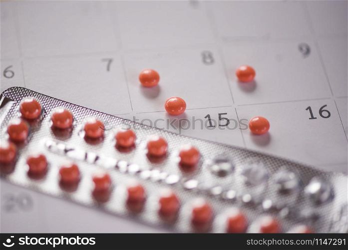 Contraceptive pill Prevent Pregnancy Contraception concept / Birth Control with calendar background - health care and medicine