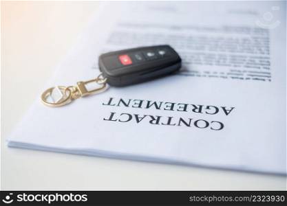 contract document with car and remote key. buy and sale, insurance, rental and contract agreement concepts