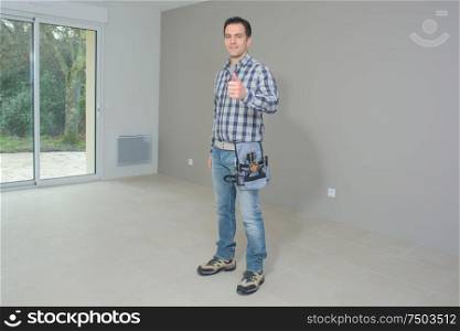 contractor making thumbs up gesture indoors