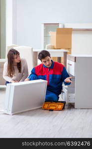 Contractor repairman assembling furniture under woman supervision