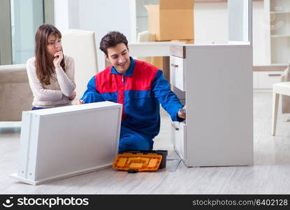 Contractor repairman assembling furniture under woman supervision