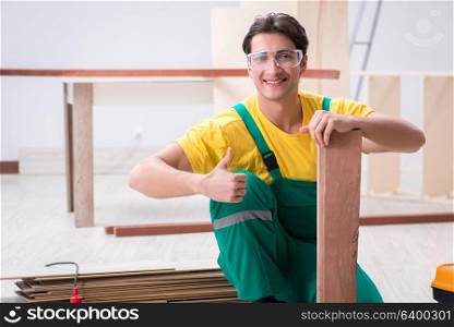 Contractor working on laminate wooden floor