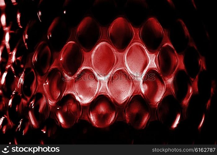 Contrast red glass background with geometric pattern macro