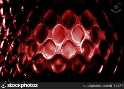 Contrast red glass background with geometric pattern macro