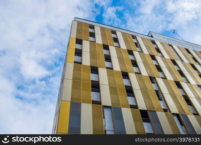 Contrasting colors and shapes on building facade against the sky in the city center of Manchester, UK