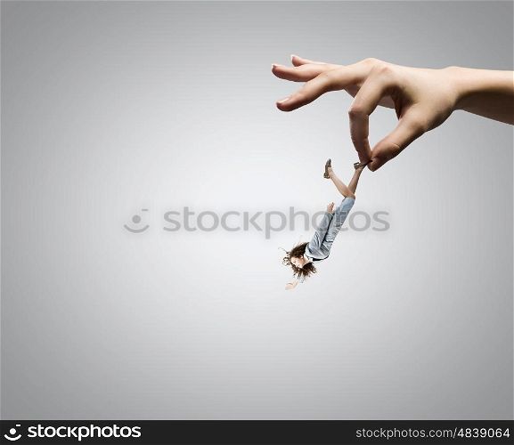 Control and power. Close up of big human hand catching businesswoman