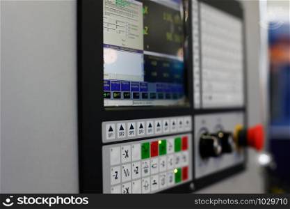 Control panel of a CNC lathe machine. Selective focus.