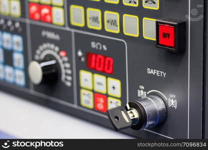 Control panel of modern industrial equipment. Close up view. Selective focus on SAFETY key switch.