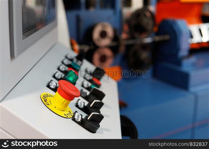 Control panel of the computer-aided manufacturing line. Selective focus on the emergency stop button.