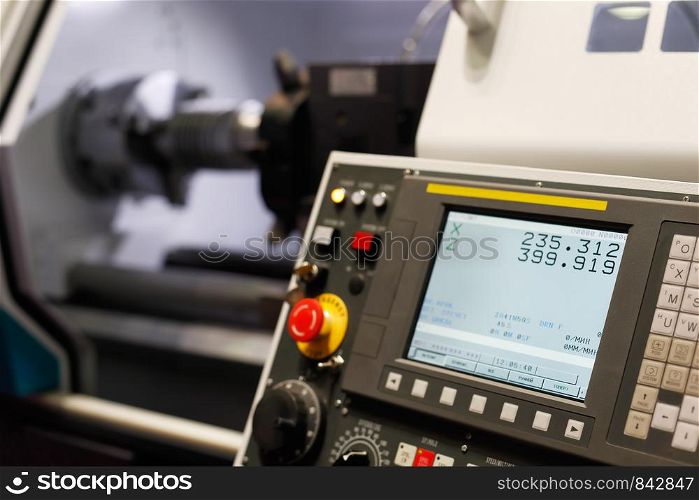 Control panel of the lathe machine with computer numerical control (CNC). Selective focus