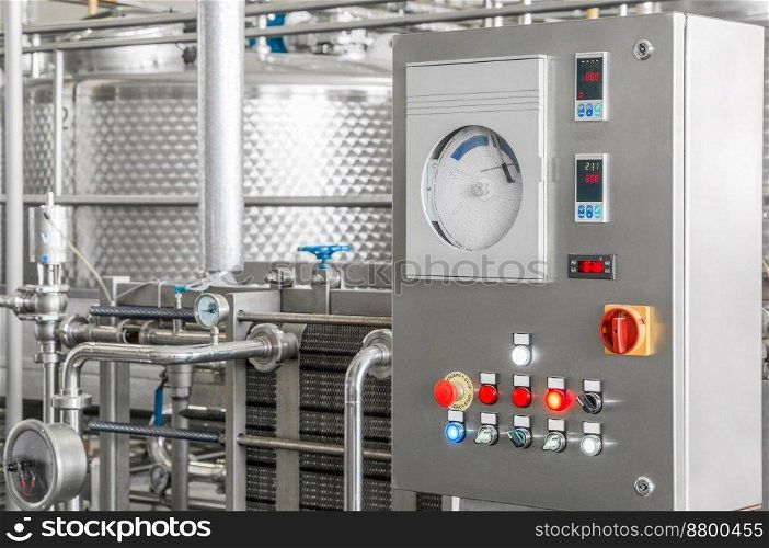 control panel with buttons and a tank at a beverage factory, close-up. factory shop for the production of glass bottles and beverage. equipment at the beverage factory