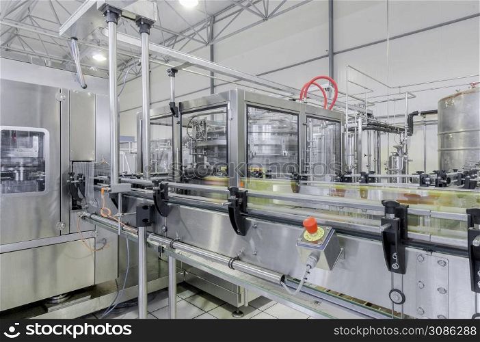 conveyor belt in motion at production and bottling of drinks in tin cans. production and bottling of drinks in tin cans. factory for bottling beverages in cans