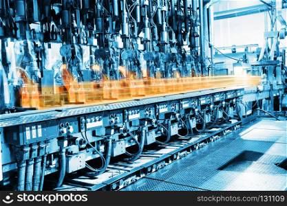 Conveyor for the production of glass bottles in glass factory. Conveyor for the production of glass bottles