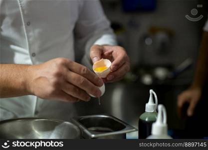 Cook breaking eggs. egg yolk