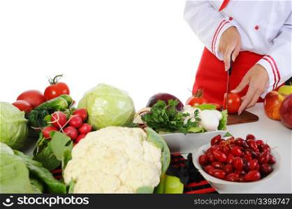 Cook cuts the vegetables. Isolated on white background